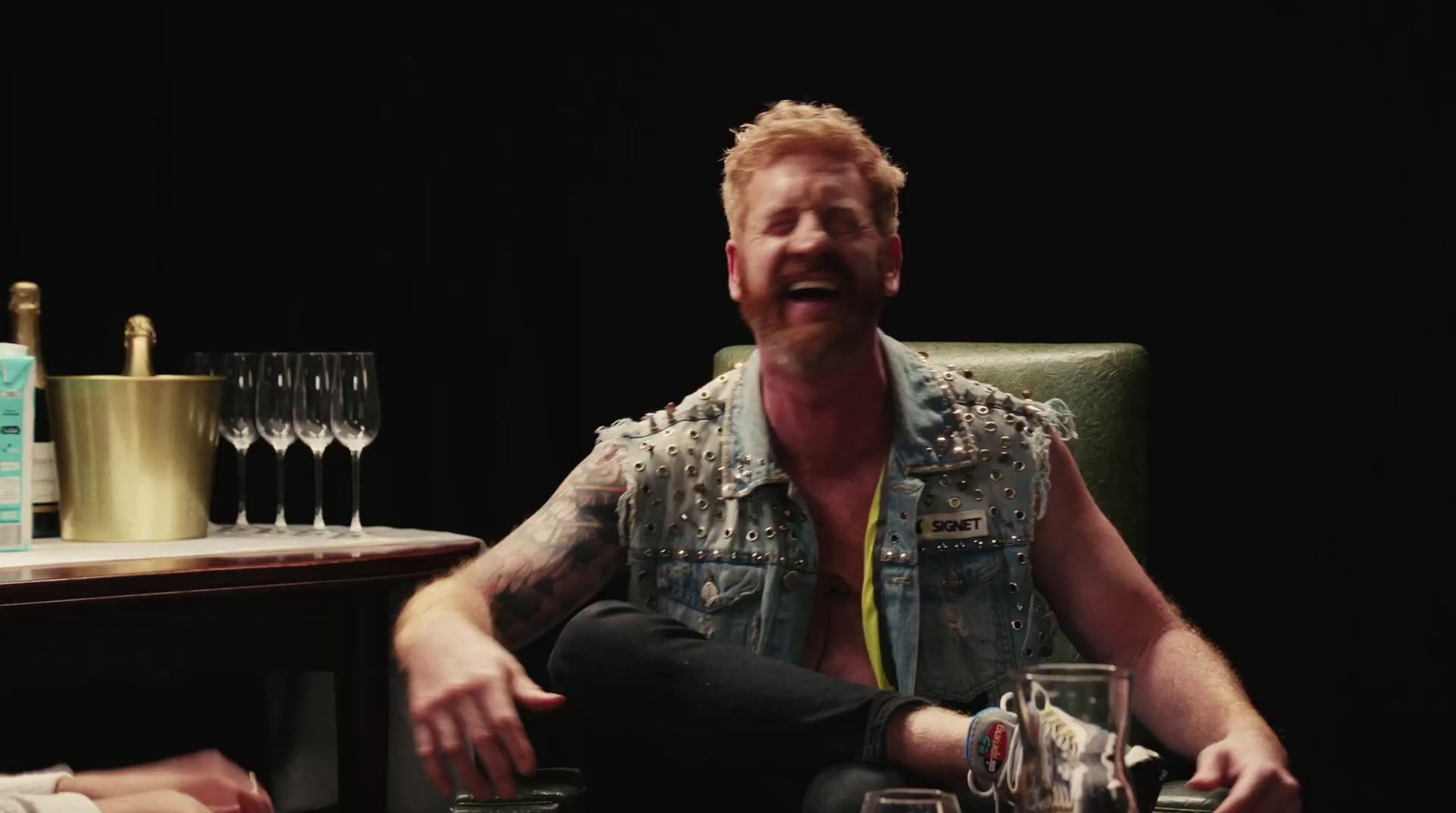 a man sitting in a chair in front of a table