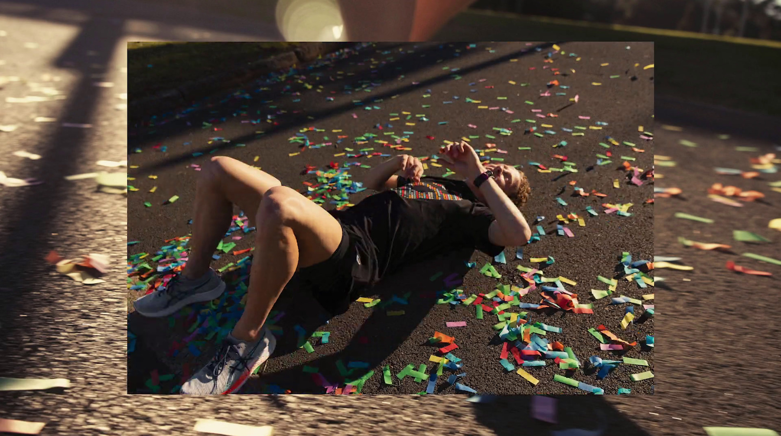 a man laying on the ground surrounded by confetti