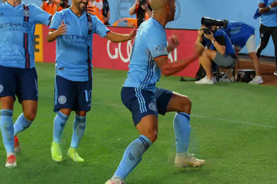 a group of people on a field playing soccer