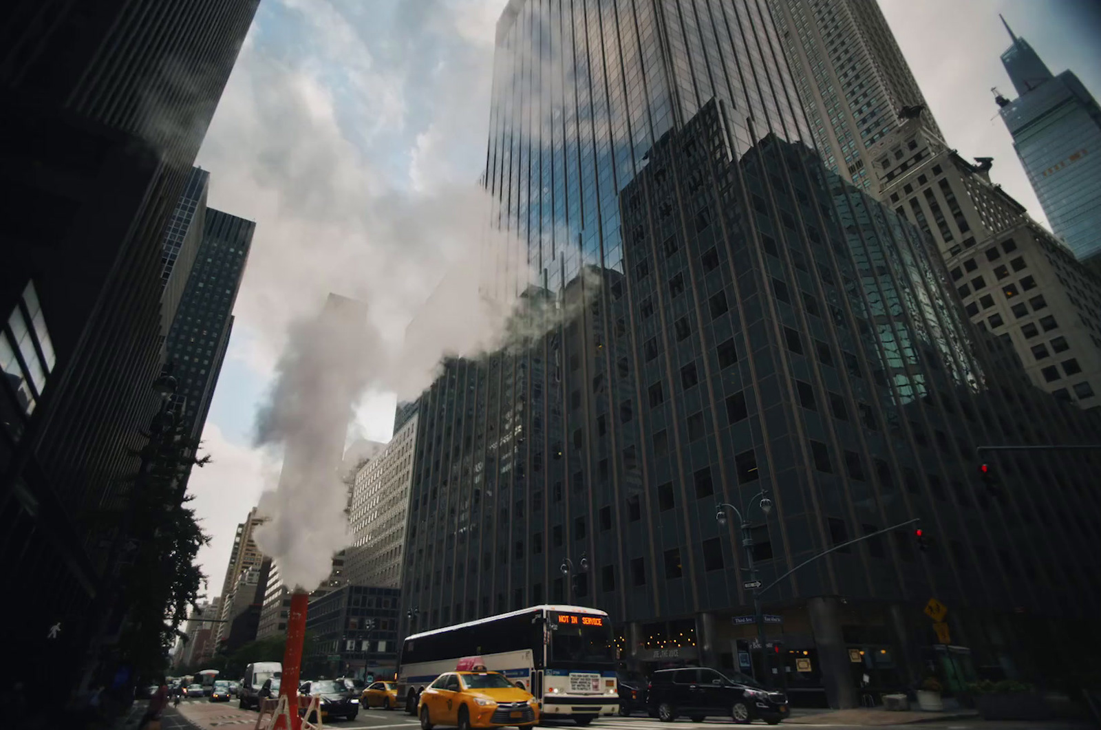 a bus driving down a street next to tall buildings