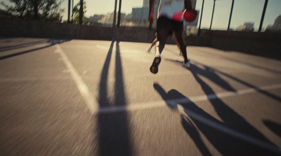 a man is running with a frisbee in his hand