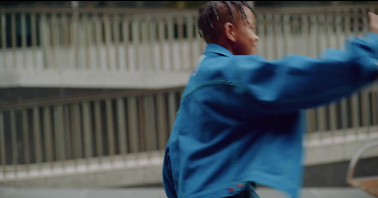 a man in a blue jacket throwing a frisbee