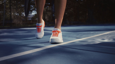 a tennis player's feet on a tennis court