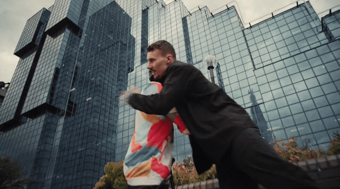 a man in a suit is holding a kite