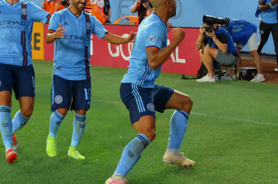 a group of men on a field playing soccer