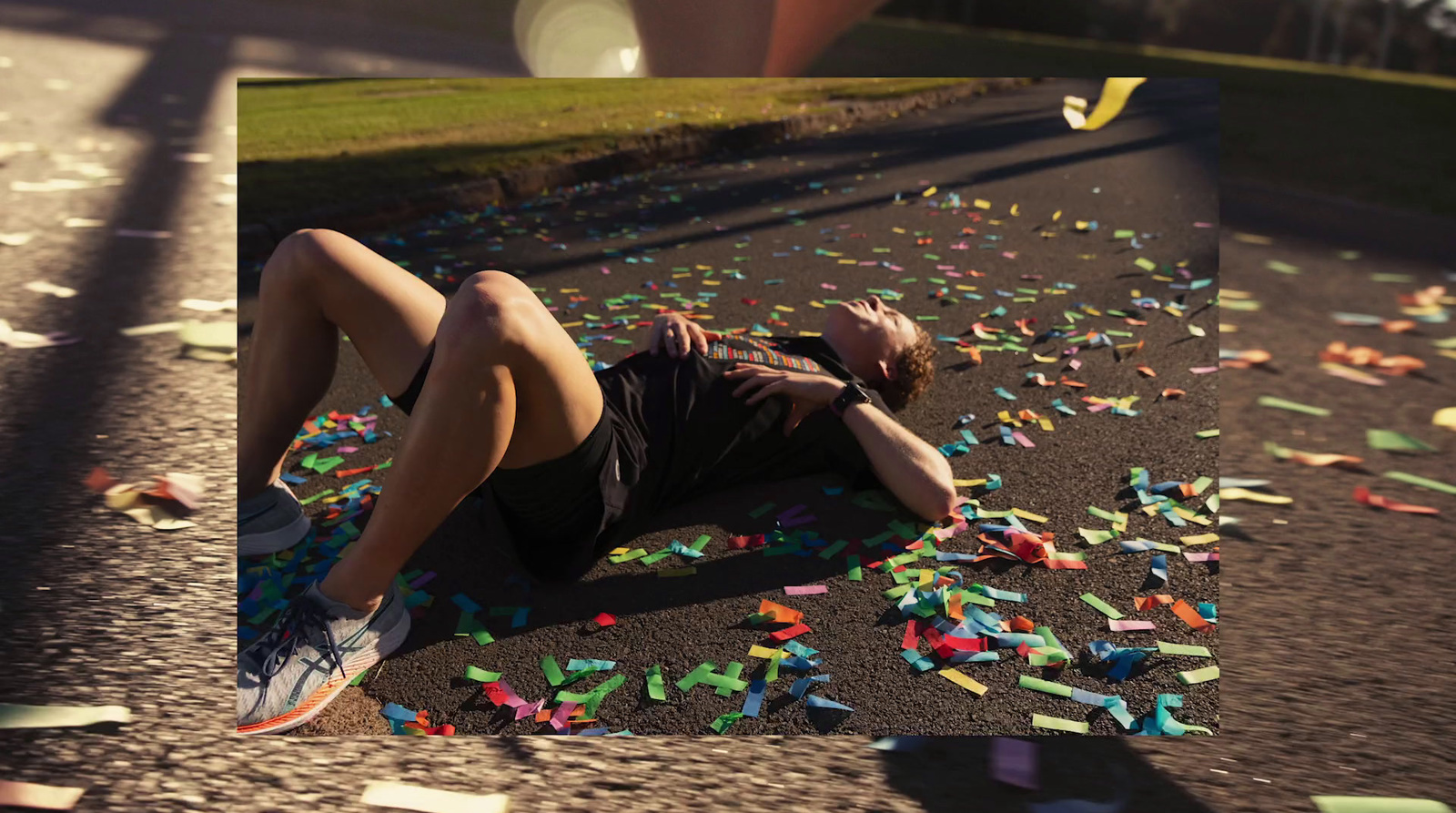 a man laying on the ground surrounded by confetti