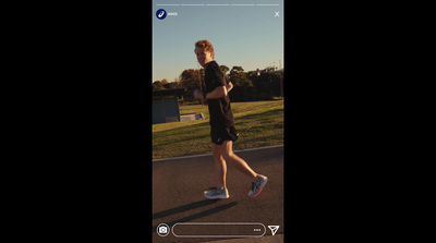 a man running down a street in a black shirt