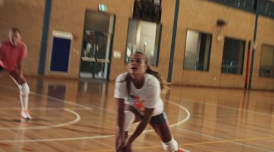 a couple of girls playing a game of basketball