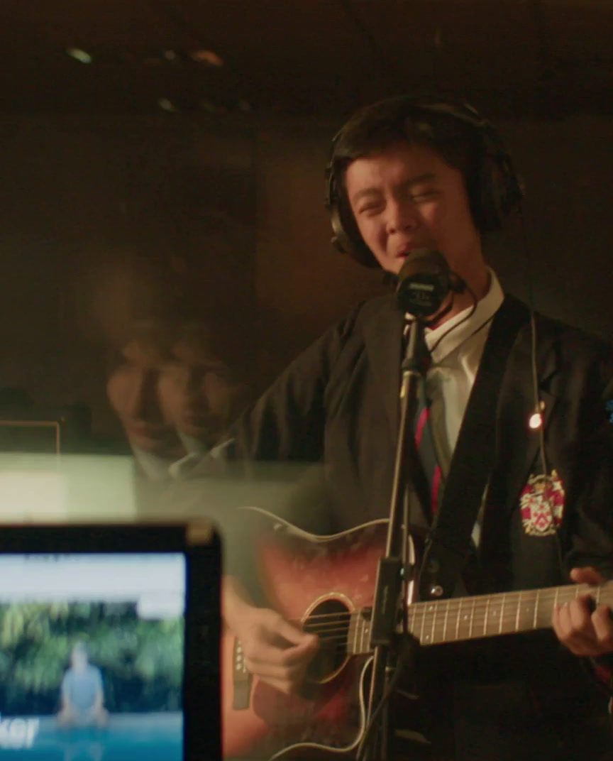 a man with headphones on playing a guitar