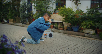 a man sitting on the ground taking a picture