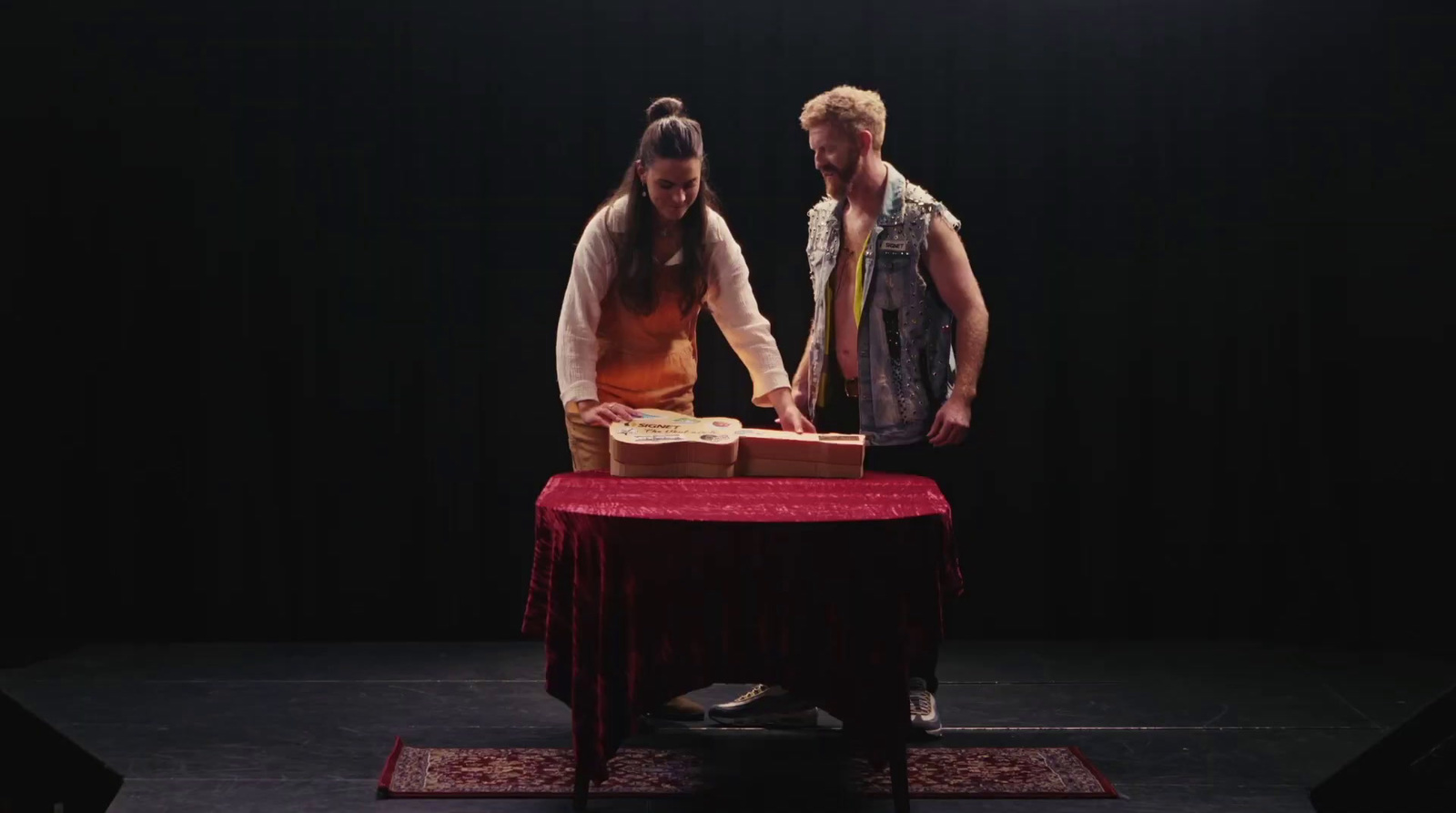 a man and a woman standing in front of a table