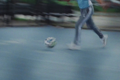 a blurry photo of a person kicking a soccer ball