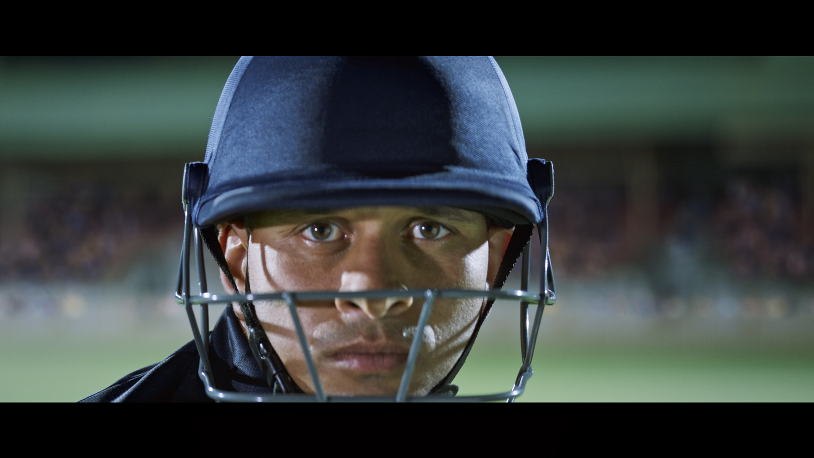 a man wearing a helmet with a baseball bat in his mouth