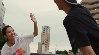 a man standing next to a woman on top of a bridge