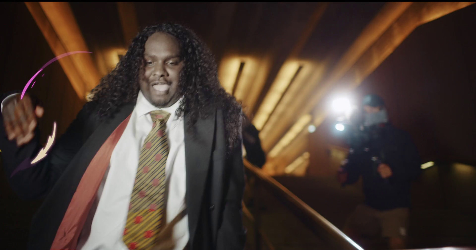 a man in a suit and tie holding a hoop