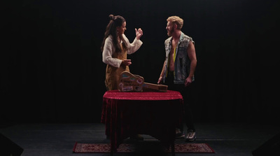 a man and a woman standing in front of a table