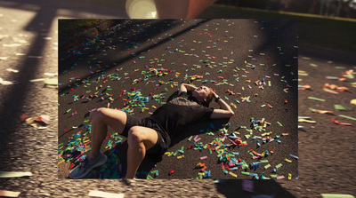 a man laying on the ground surrounded by confetti