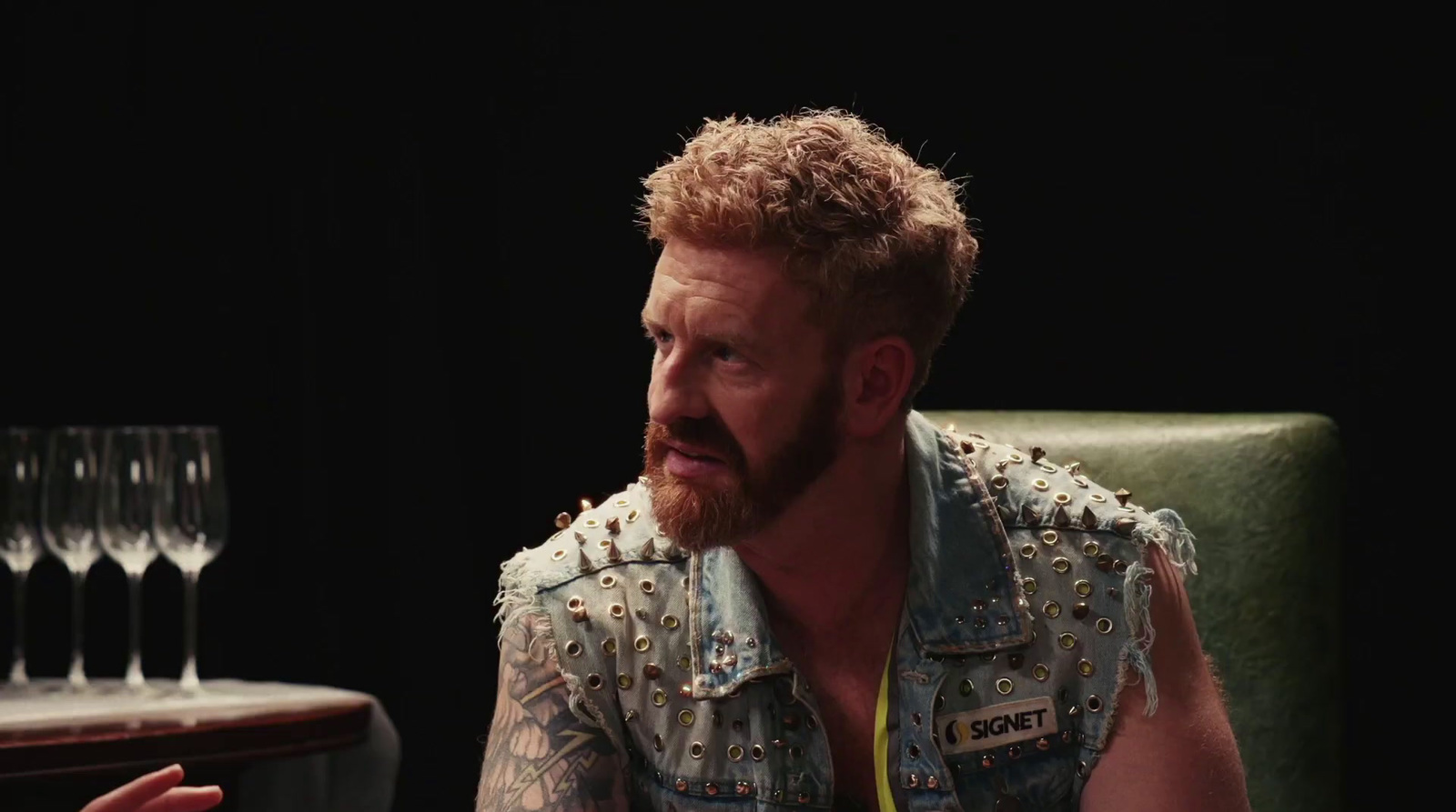 a man with a beard sitting in a chair