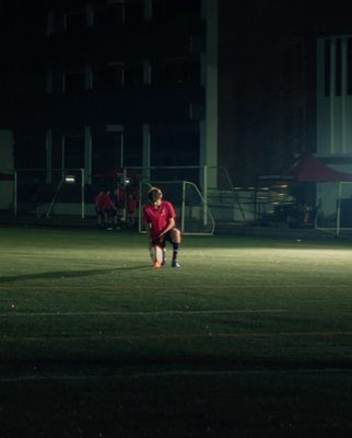 a person on a field with a soccer ball