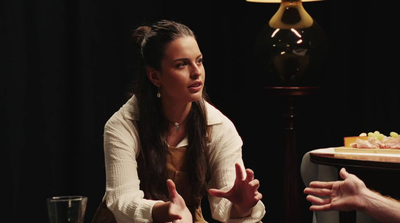 a man and a woman sitting at a table talking