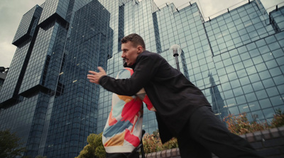 a man in a suit is throwing a frisbee