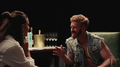 a man and a woman sitting at a table talking