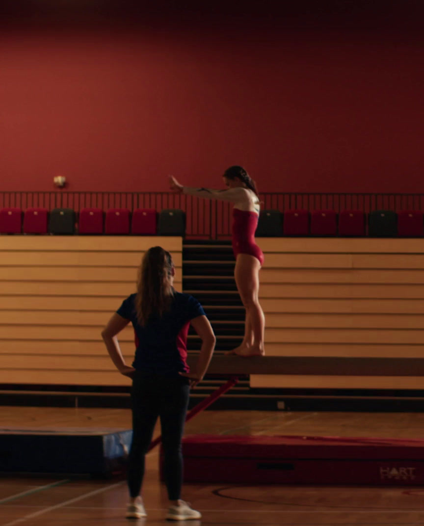 a woman in a red leotard and a woman in a white leotar