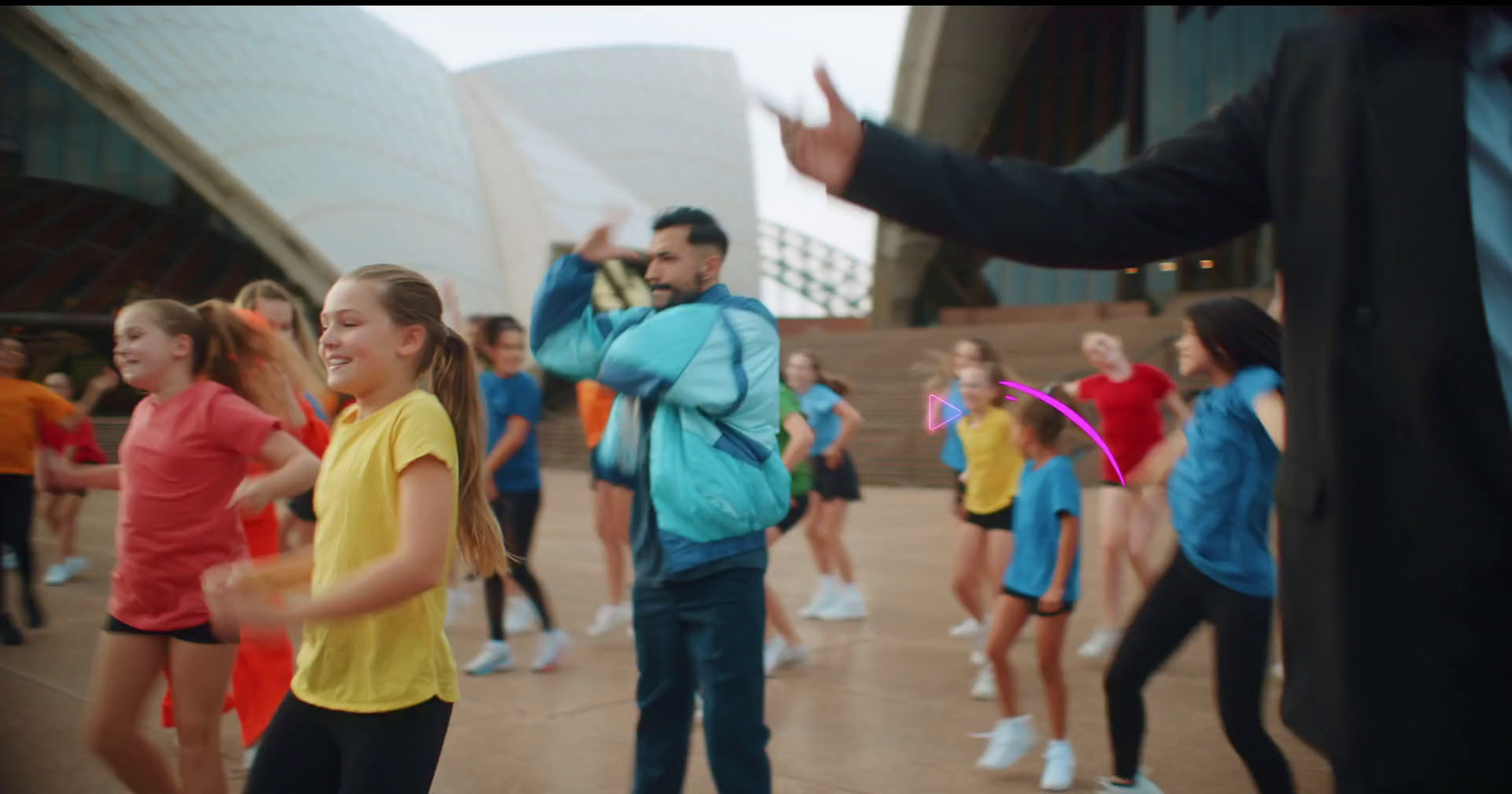 a group of people dancing in front of a building