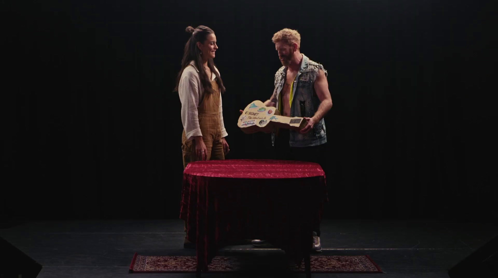 a man and a woman standing in front of a table