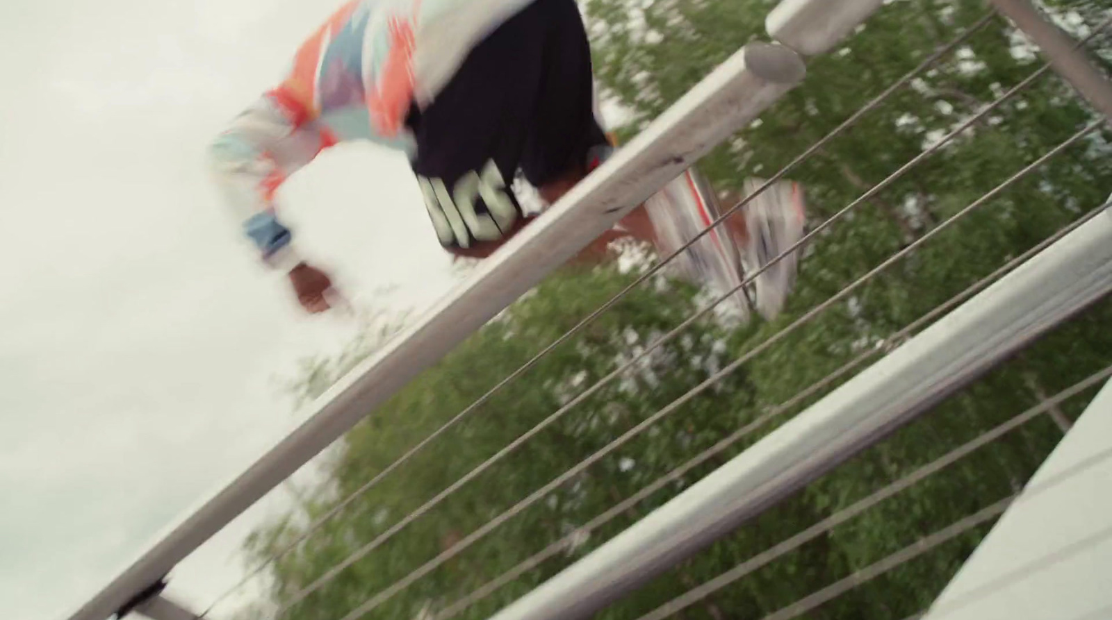 a man riding a skateboard down a metal rail