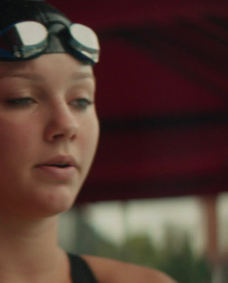 a woman wearing goggles and a black tank top