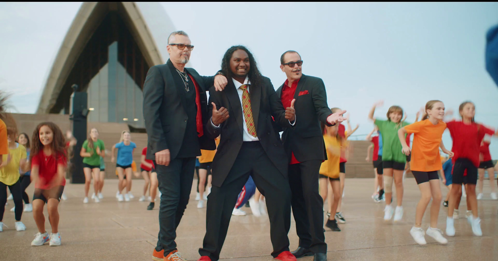 a group of men in suits and ties dancing