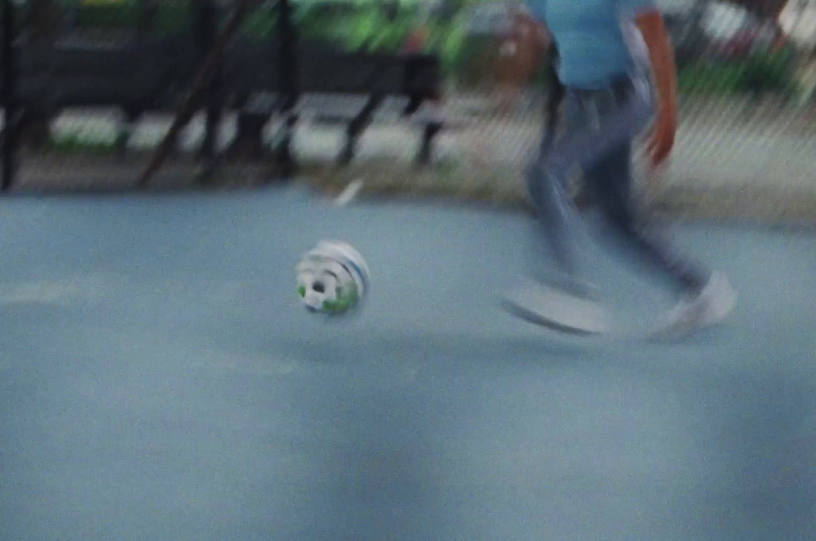 a blurry photo of a person kicking a soccer ball