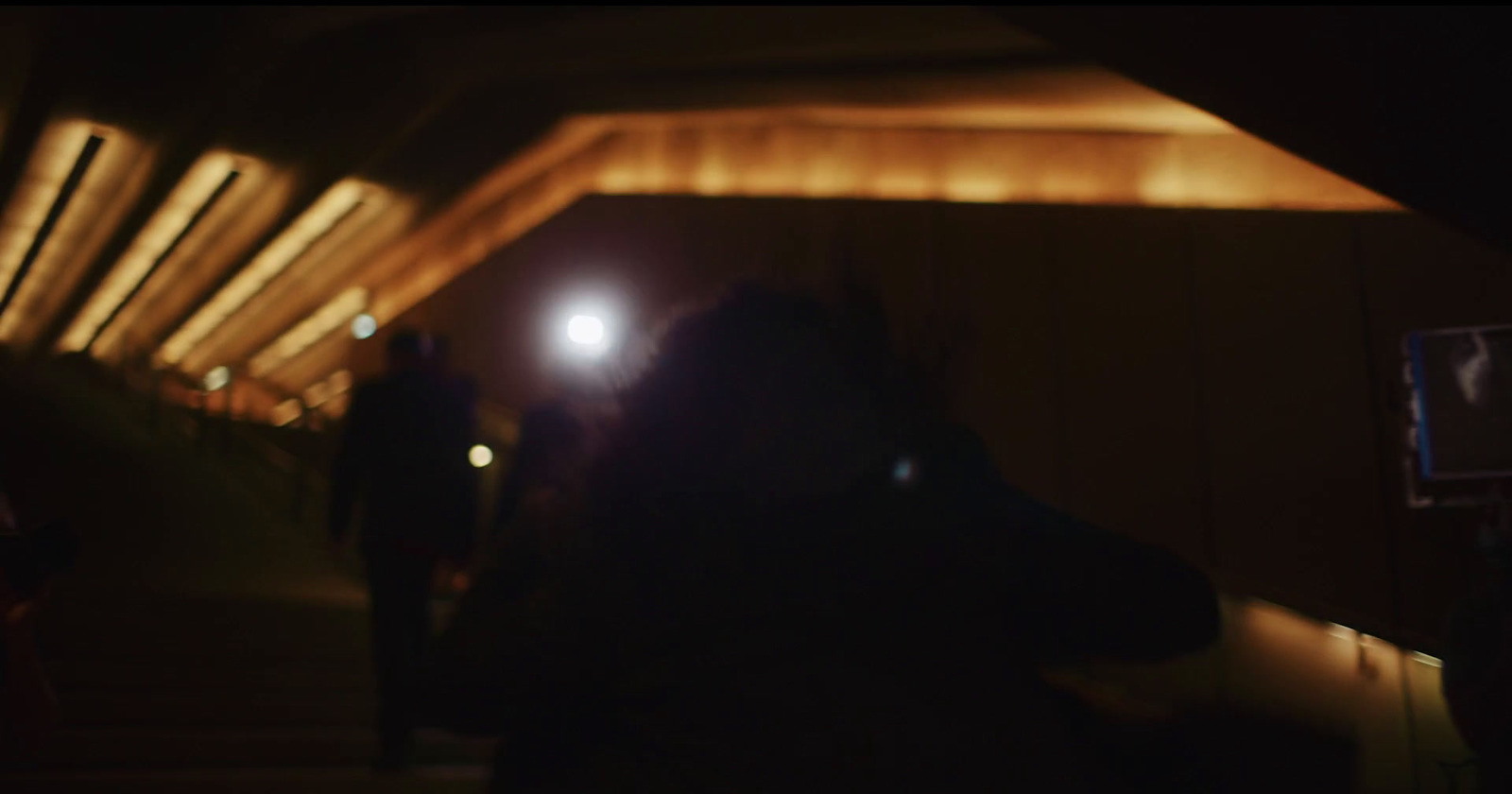 a blurry photo of a person standing in a tunnel