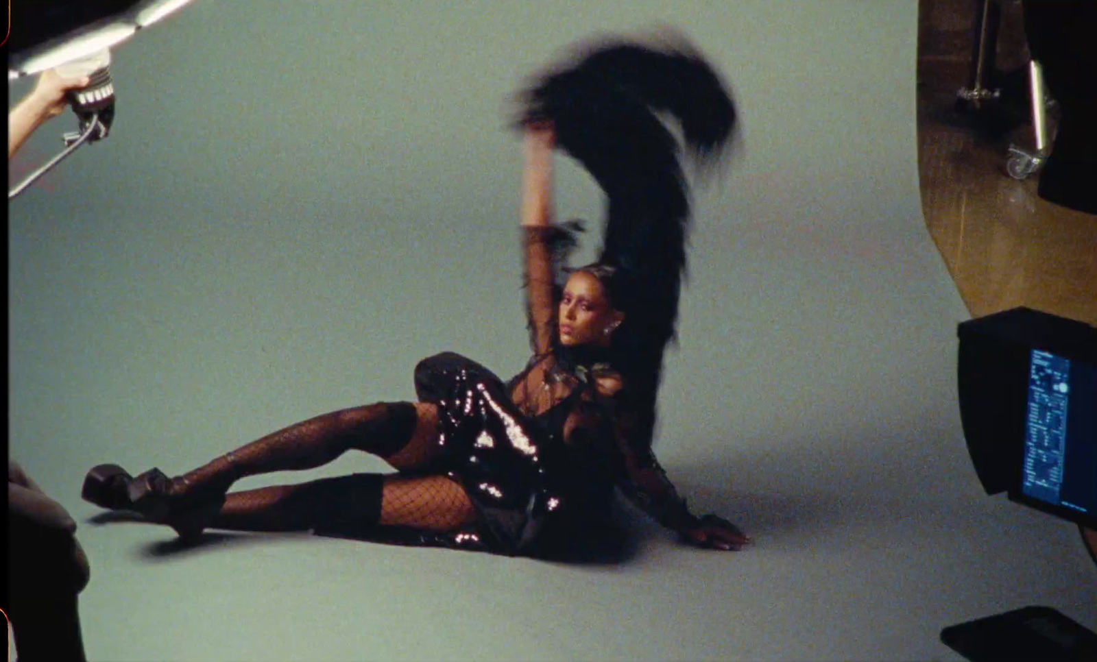 a woman sitting on the ground with her legs spread out