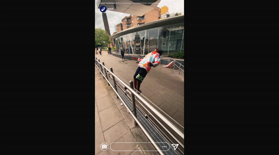 a man riding a skateboard down a metal rail