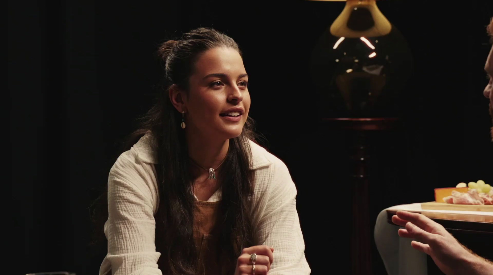 a man and a woman sitting at a table talking