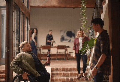 a man sitting in a wheel chair next to a woman