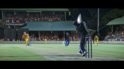 a group of men playing a game of cricket