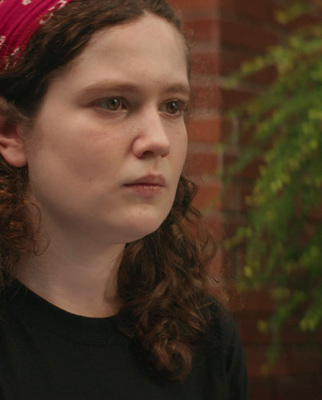 a woman with a red bandana on her head