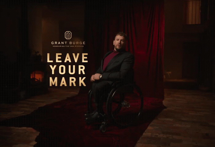 a man in a suit sitting in a wheel chair