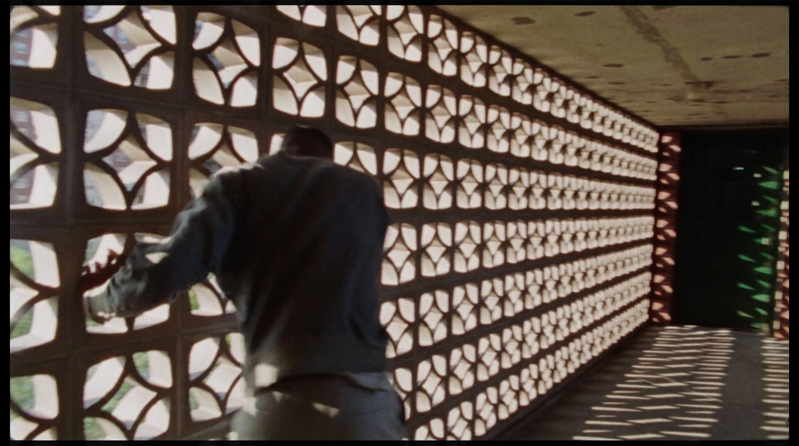 a man standing in front of a wall made of circles