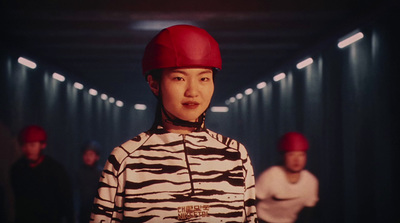 a woman wearing a red helmet standing in a hallway