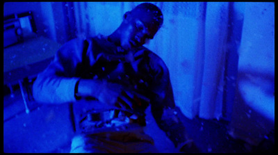 a man sitting in a room with a blue light