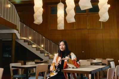 a woman sitting at a table in a restaurant