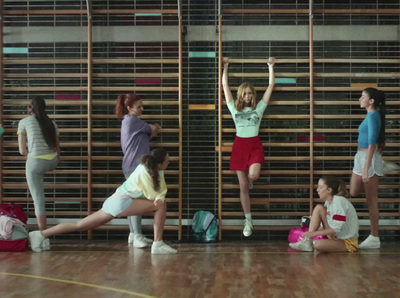 a group of young women standing on top of a wooden floor