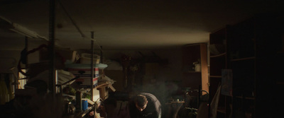 a man standing in a kitchen next to a stove top oven