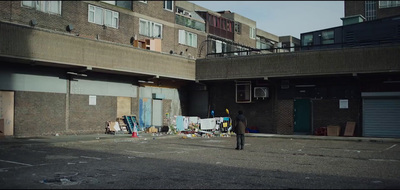 a person standing in an empty parking lot