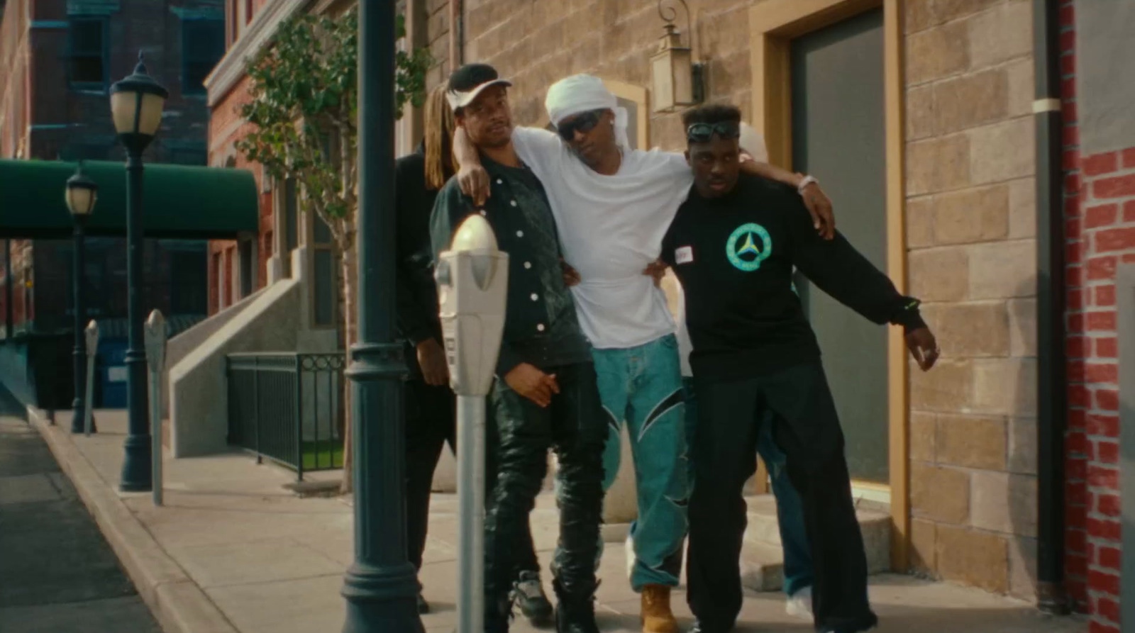 a group of men standing next to each other on a sidewalk