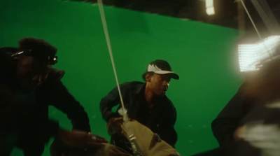 a man standing in front of a green screen